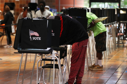 MIAMI, FLORIDA - OCTOBER 21: Voters fill out their ballots as they vote at the Stephen P. Clark Government Center polling station on October 21, 2020 in Miami, Florida. The state of Florida saw a record-breaking first day of early voting with over 3.1 million votes cast. The early voting ends on Nov. 1. Voters are casting their ballots for presidential candidates President Donald Trump and Democratic presidential nominee Joe Biden.   Joe Raedle/Getty Images/AFP