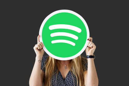 Cheerful woman holding emoticon icon