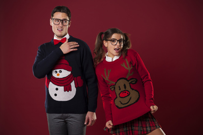 Crazy nerd couple in funny sweaters goofing around