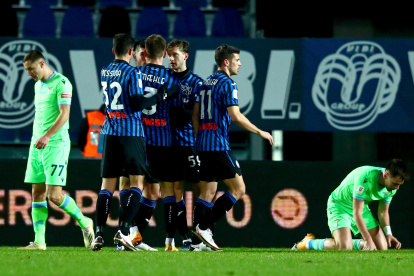 Los jugadores del Atalanta festejan ante el lamento de los jugadores de la Lazio.