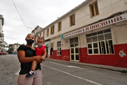 Una madre con su hija en brazos posa para Efe en una calle hoy, en La Habana (Cuba). EFE/ Yander Zamora