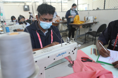 Eduardo Zambrano diseña y cose vestidos en el taller de industria de la confección, donde es el único estudiante varón de su clase.