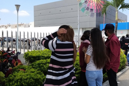 Los familiares de uno de los reos asesinados, peregrinan fuera de la morgue, en Guayaquil.