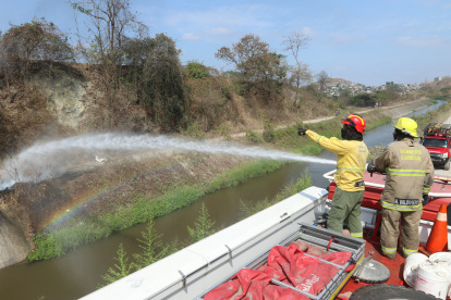 Una llanta envuelta en llamas es apagada por los bomberos en la cooperativa Janeth Toral.