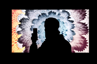 Imagen de archivo de una persona que toma una foto de una obra de arte digital de NFT