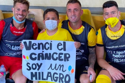 Luis Daniel Samaniego, pequeño hincha de Barcelona, junto a Damián Díaz, Javier Burrai (i) y Paco Rodríguez (d)