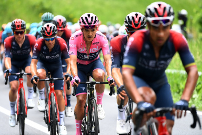 Richard Carapaz (c) vistiendo la maglia rosa de líder en la etapa 16 de la carrera.