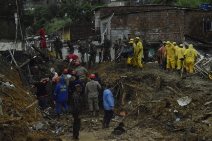 Bomberos, soldados del ejército y voluntarios trabajan en el área de un deslizamiento de tierra provocado por fuertes lluvias hoy, en el barrio Jardim Monteverde de la ciudad de Jaboatão dos Guararapes (Brasil