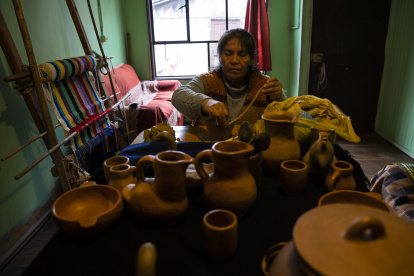 Julia Matamala Llancao, wizüfe, alfarera mapuche, es vista mientras trabaja en la confección de piezas con greda y ücu, un tipo de arena fina que le otorga brillo, en su vivienda situada en la comunidad Quechocahuín, el 20 de junio de 2022 en Puerto Domínguez en la Araucanía (Chile). EFE/Alberto Valdés