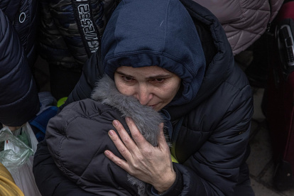 Una madre con su hijo trata de huir de Kiev
