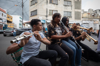 Alumnos del profesor de música Juan Manuel Mejías ensayan el 21 de junio de 2022, en una calle de Caracas (Venezuela).