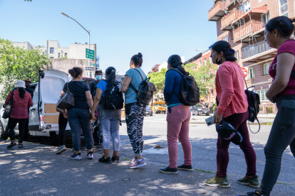 NUEVA YORK. Un grupo de mujeres jornaleras inmigrantes reciben comida mientras esperan ser contratadas para trabajos de limpiezas.