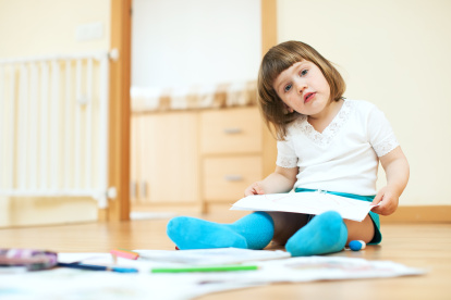 calm two year child sketching on paper in home interior
