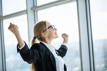 Business woman excited hold hands up raised arms celebrate victory . concept winner success in modern office