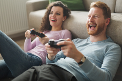 Beautiful couple playing video games on console having fun
