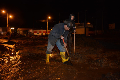 Ciudadanos tratando de limpiar las calles luego del deslave.
