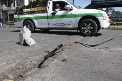 Alerta. Dos rocas se colocaron frente al desperfecto que hay en el puente.