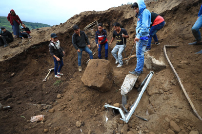 Pobladores y rescatistas buscan a víctimas de un alud hoy, en Alausí (Ecuador).