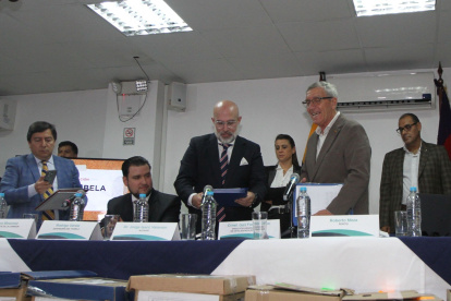 Acto. Fausto Cobo y Arturo Moscoso, durante la entrega del informe a Patricia Ochoa, viuda de Gabela.