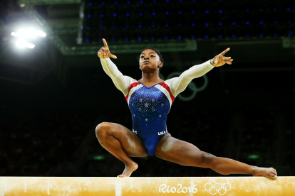 Simone Biles of the United States competes on the balance beam during the women"s individual all-around gymnastics final on Thursday. Biles won the gold and teammate Aly Raisman took the silver.