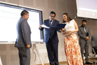 Los titulares del CES y de la Senescyt, Pablo Beltrán y Andrea Montalvo, entregan la respectiva resolución al representante de uno de los institutos.