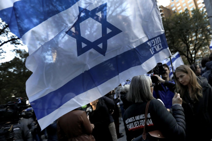 A woman holds an Israeli flag during a candlelight vigil for Israeli victims in New York, New York, USA, 01 November 2023. Thousands of Israelis and Palestinians have died since the militant group Hamas launched an unprecedented attack on Israel from the Gaza Strip on 07 October, and the Israeli strikes on the Palestinian enclave which followed it.