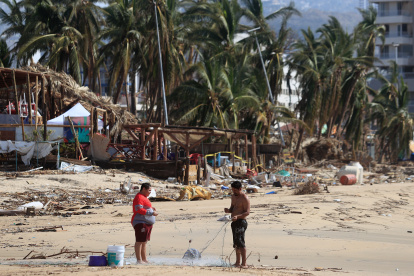 Personas permanecen un una de zonas afectadas por el paso del huracán Otis en el balneario de Acapulco, en el estado de Guerrero (México).