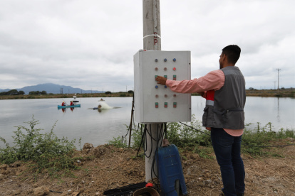 Campo. Empleado de una camaronera opera aireadores que oxigenan la piscina, que funcionan con electricidad.