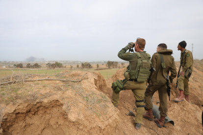 Soldados israelíes observan con prismáticos la Franja de Gaza desde el sur de Israel, el 21 de diciembre de 2023.