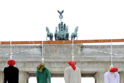 Imagen de archivo de una protesta con la ejecución simbólica de cuatro muñEFE/Robert Schlesingerecos encima de una bandera iraní frente a la Puerta de Brandeburgo, en Berlín.