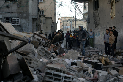 Un grupo de palestinos buscan personas desaparecidas bajo los escombros tras un ataque aéreo israelí en Khan Yunis, en el sur de la Franja de Gaza, el 7 de enero de 2024.