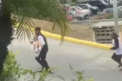 Un video facilitado por el IESS muestra a un guardia del Hospital de los Ceibos cargando a la menor hacia el área de Emergencia.