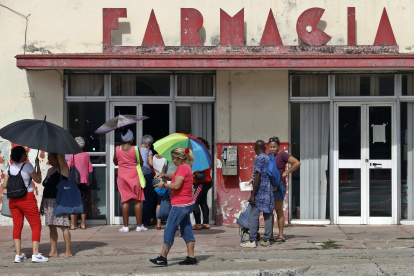 AME1047. LA HABANA (CUBA), 20/01/2024.- Personas esperan afuera de una farmacia, el 19 de enero de 2024, en La Habana (Cuba). Asegurarse suficientes almohadillas femeninas (toallas sanitarias o compresas) para el período menstrual se ha convertido en un verdadero dolor de cabeza para cada vez más cubanas en los últimos meses. Con la persistente crisis que azota al país, más de tres millones de cubanas tienen que "inventar" cada mes ante la escasez de este producto de primera necesidad, que ha desaparecido de las farmacias estatales y se encuentra solamente a elevados precios en tiendas en divisa y negocios de revendedores. EFE/ Ernesto Mastrascusa