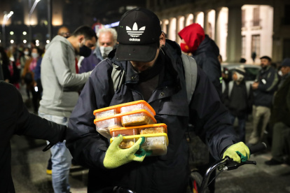 Un hombre recibe alimentos durante una "Olla popular" en Montevideo.