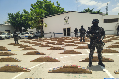 Agente de la Policía muestran los paquetes de droga encontrada en una finca cerca de la ciudad portuaria de Manta, provincia de Manabí.