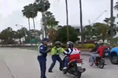 Momento en el que el agente intentó, sin suerte, de detener al motociclista.