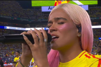 Karol g cantando el Himno Nacional.