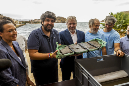 El presidente de la Comunidad de Murcia, Fernando López Miras, el alcalde de Mazarrón, Ginés Campillo, el arqueólogo de la Universidad de Valencia, Carlos de Juan, muestran una parte de la proa de la embarcación fenicia Mazarrón II.