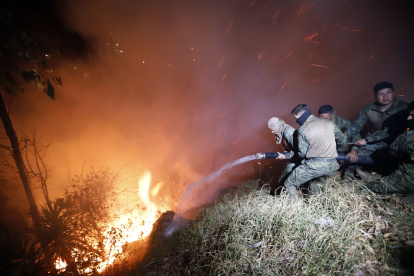 Personal de las Fuerzas Armadas trabaja para sofocar un incendio.