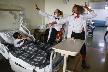 Los payasos Waldisney (i) y Sandoval (d) visitan a un paciente en el Hospital Universitario de São Paulo.