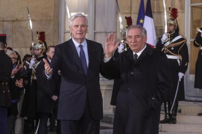 El primer ministro saliente de Francia, Michel Barnier (izq.), y el nuevo primer ministro de Francia, François Bayrou (der.), saludan durante la ceremonia de traspaso en el Hotel Matignon en París, Francia, el 13 de diciembre de 2024.