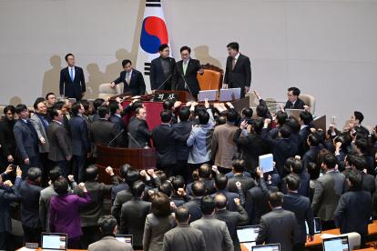 Los legisladores del gobernante Partido del Poder Popular discuten con el presidente de la Asamblea Nacional, Woo Won-shik este viernes.