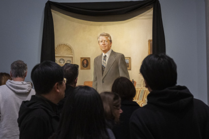 Los visitantes de la Galería Nacional de Retratos del Smithsonian contemplan un retrato del expresidente estadounidense Jimmy Carter en la Oficina Oval de la Casa Blanca.