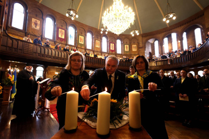 Los miembros de la congregación encienden velas durante un Servicio de Oración Interreligioso por la Paz en Ucrania en la Catedral Católica Ucraniana de la Sagrada Familia.