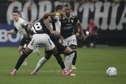 Memphis Depay (c) de Corinthians disputa el balón con Bryan Carabalí (i) de Barcelona.