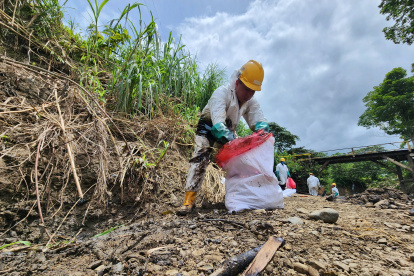 Limpieza. Un obrero de Petroecuador limpia la orilla del río Caple, contaminada por el derrame de crudo.