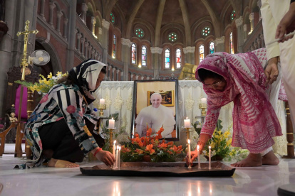 Fieles rinden homenaje junto a un retrato del difunto papa Francisco en la Iglesia Catedral de la Resurrección en Lahore, Pakistán, el 22 de abril de 2025.
