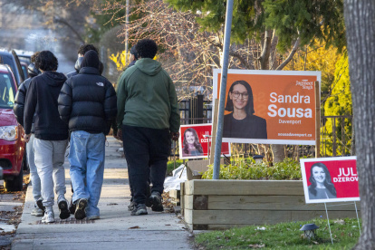 Vista general de un grupo de transeúntes el pasado 21 de abril al caminar por calle en la que se ven carteles de propaganda electoral. Toronto, Canadá.