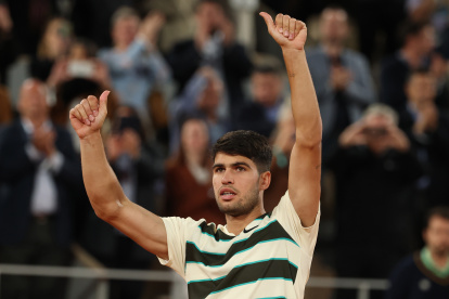 Carlos Alcaraz levanta las manos en señal de victoria cuando Musetti decidió retirarse cuando iban 4-6, 7-6(3), 6-0 y 2-0.