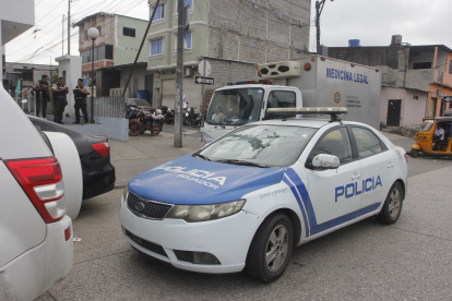 Agentes policiales luego de las pericias por el hallazgo de los cuerpos de cuatro comerciantes en Nueva Prosperina, en el noroeste de Guayaquil, este viernes 6 de junio.